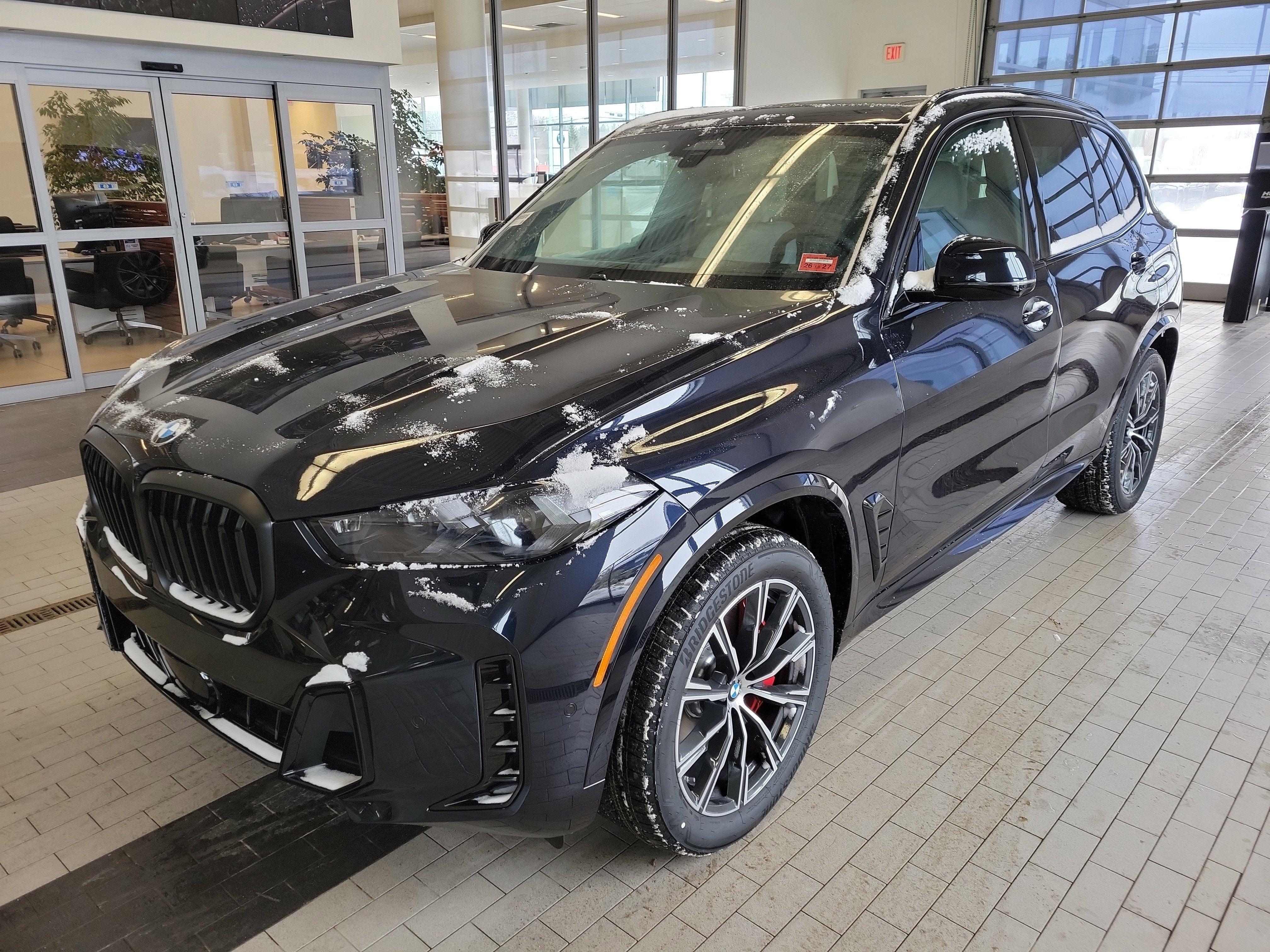 2026 BMW X5 xDrive40i in Carbon Black Metallic — front three-quarter view