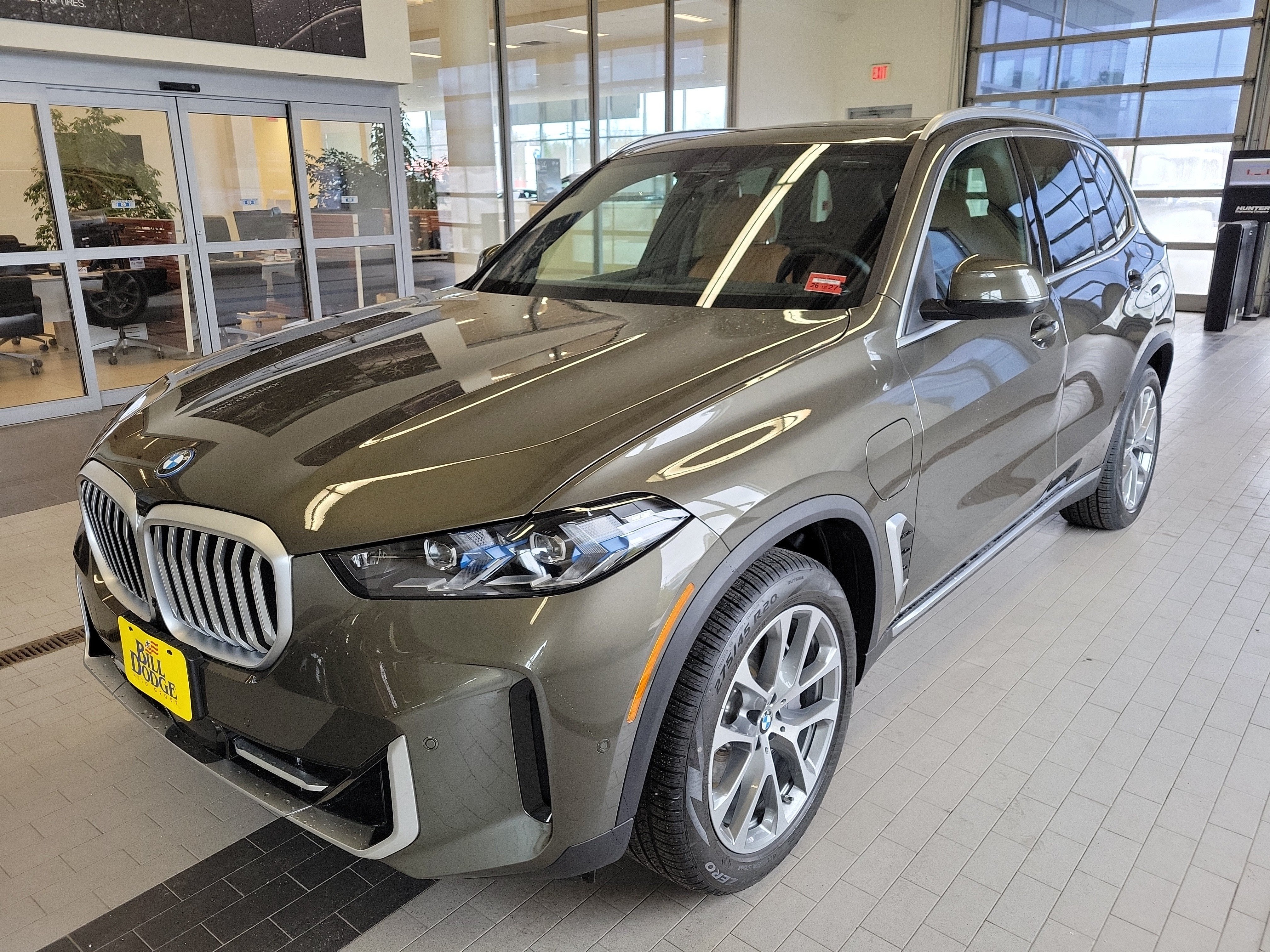 2026 BMW X5 xDrive50e in Manhattan Green Metallic — front three-quarter view