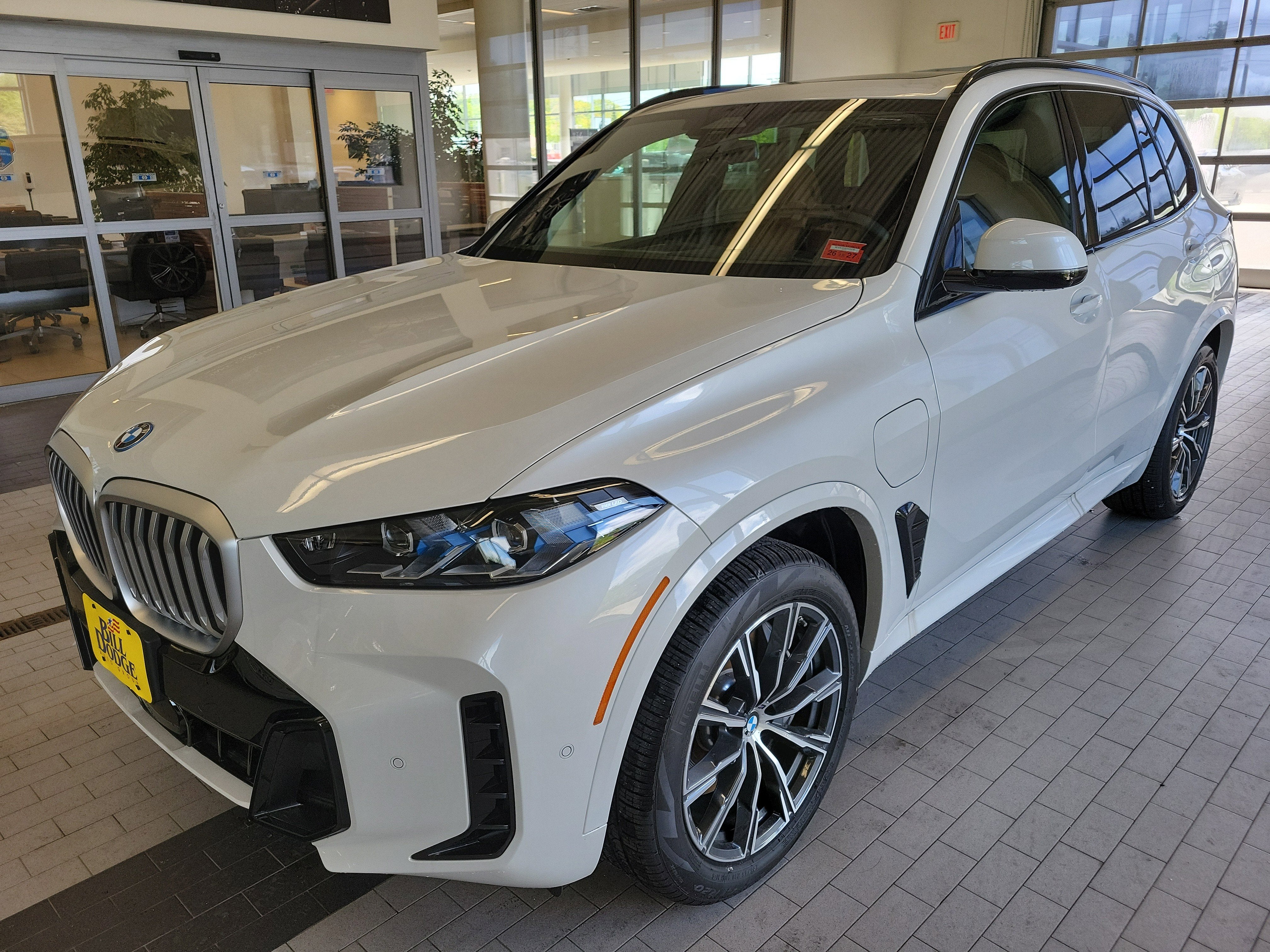 2026 BMW X5 xDrive50e in Mineral White Metallic — front three-quarter view