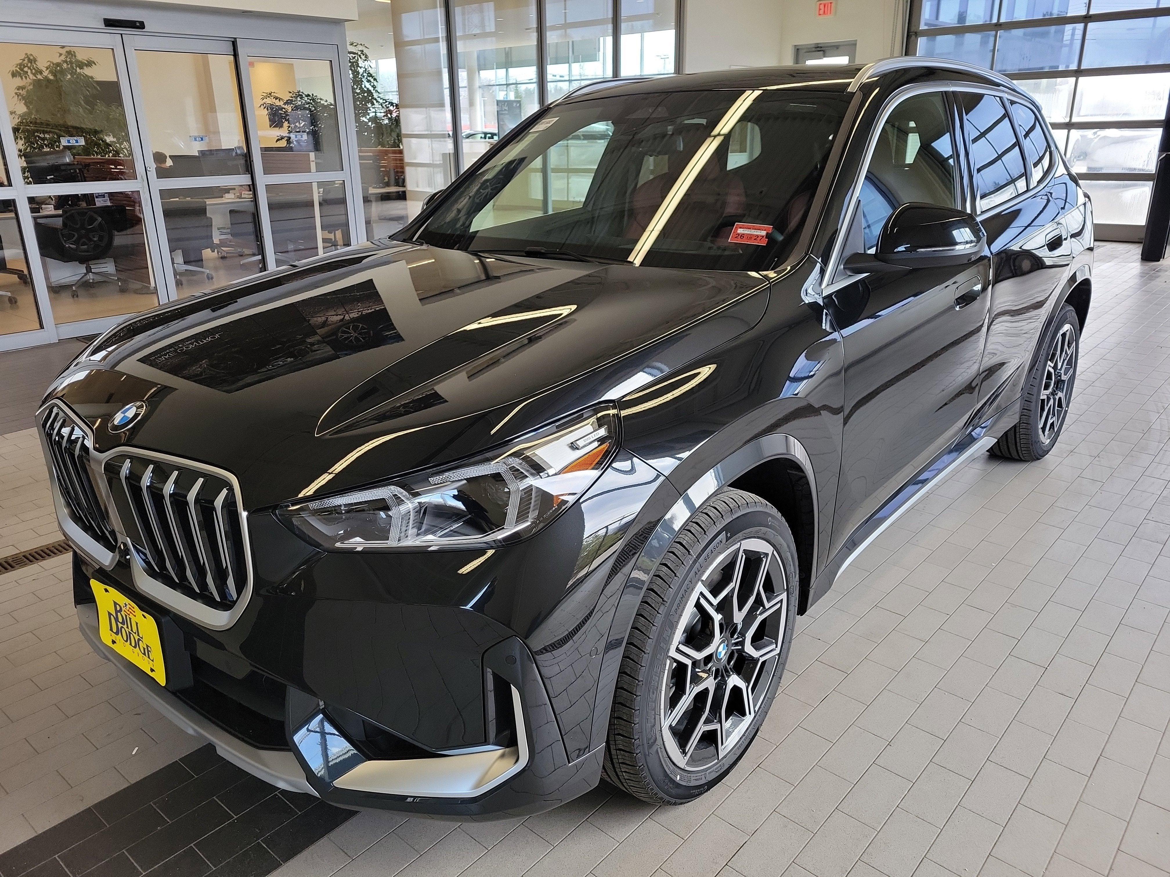2026 BMW X1 xDrive28i in Black Sapphire Metallic — front three-quarter view