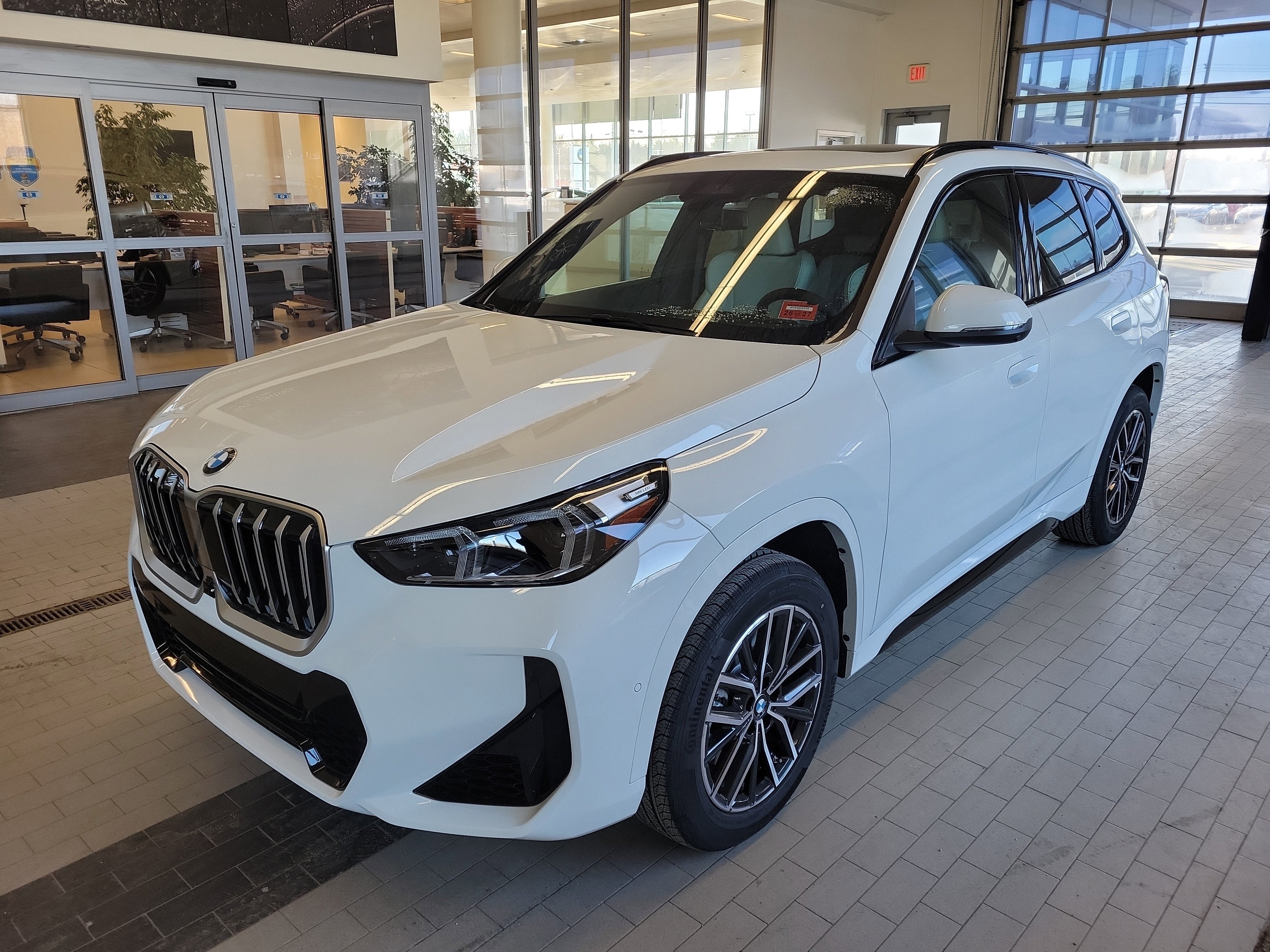 2026 BMW X1 xDrive28i in Alpine White — front three-quarter view