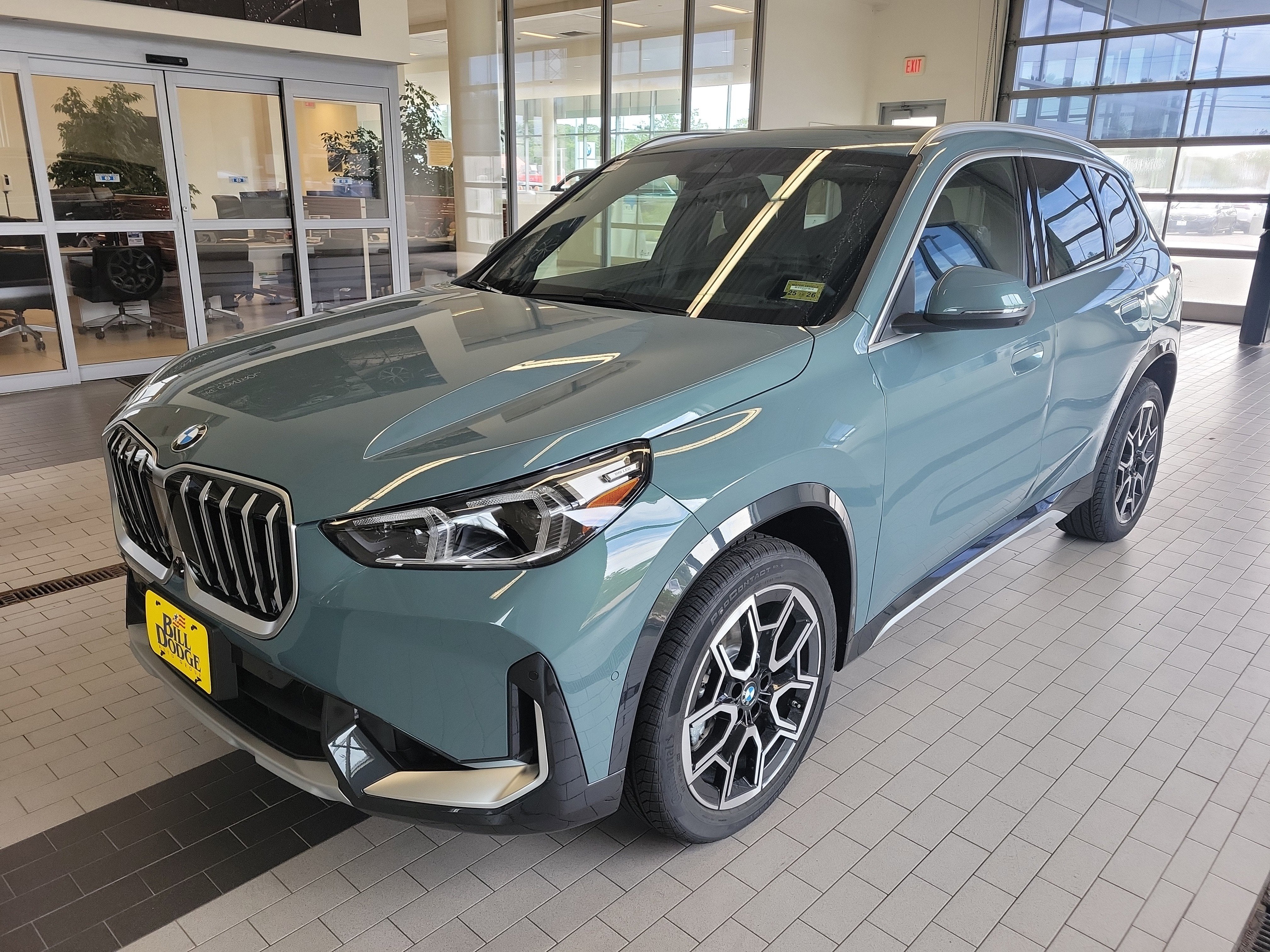 2026 BMW X1 xDrive28i in Cape York Green Metallic — front three-quarter view