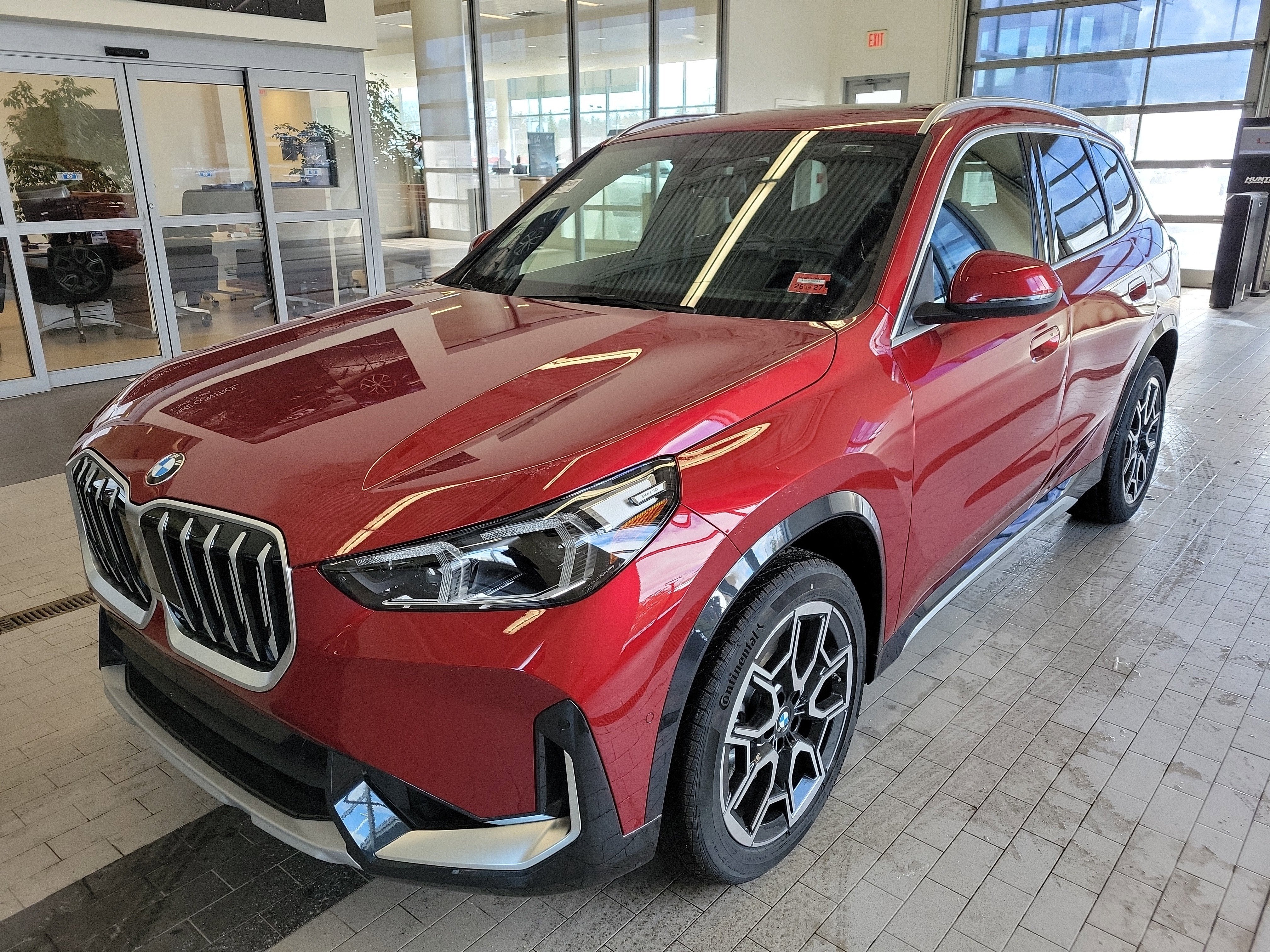 2026 BMW X1 xDrive28i in Vegas Red Metallic — front three-quarter view