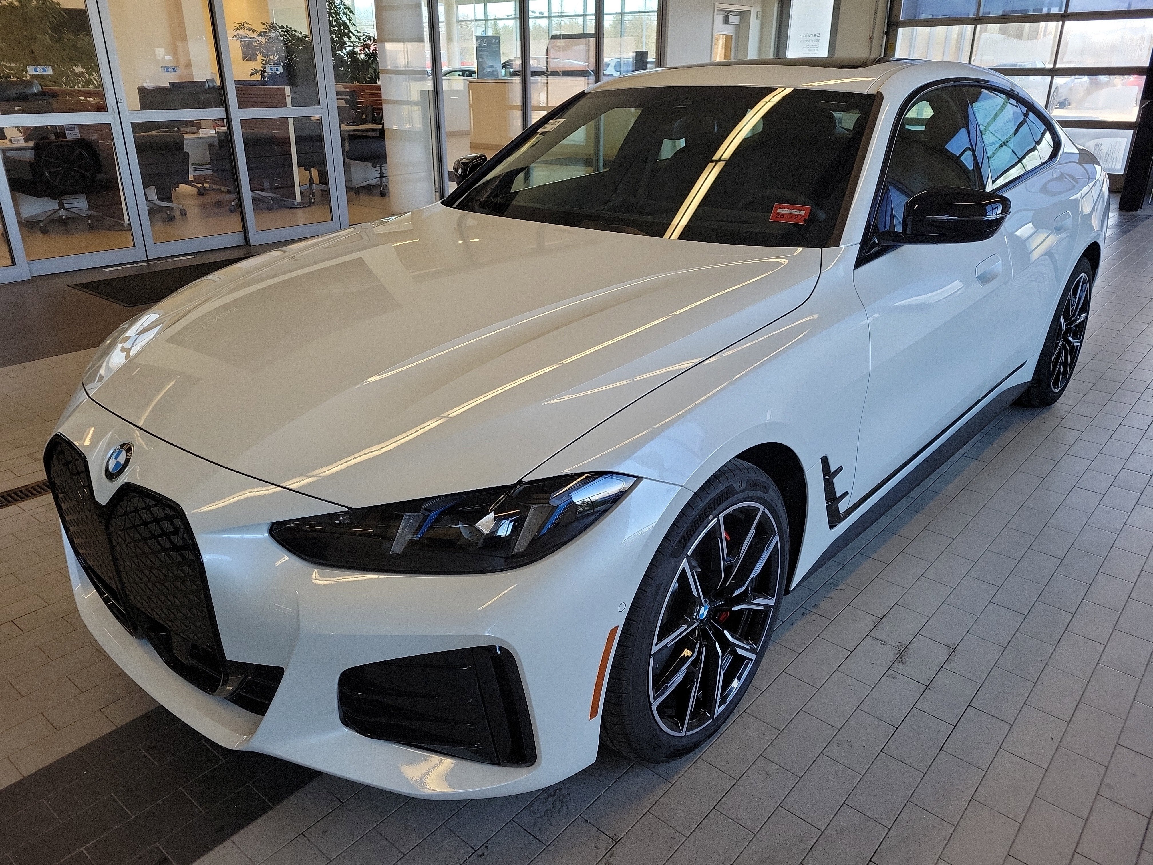 2026 BMW i4 xDrive40 in Mineral White Metallic — front three-quarter view