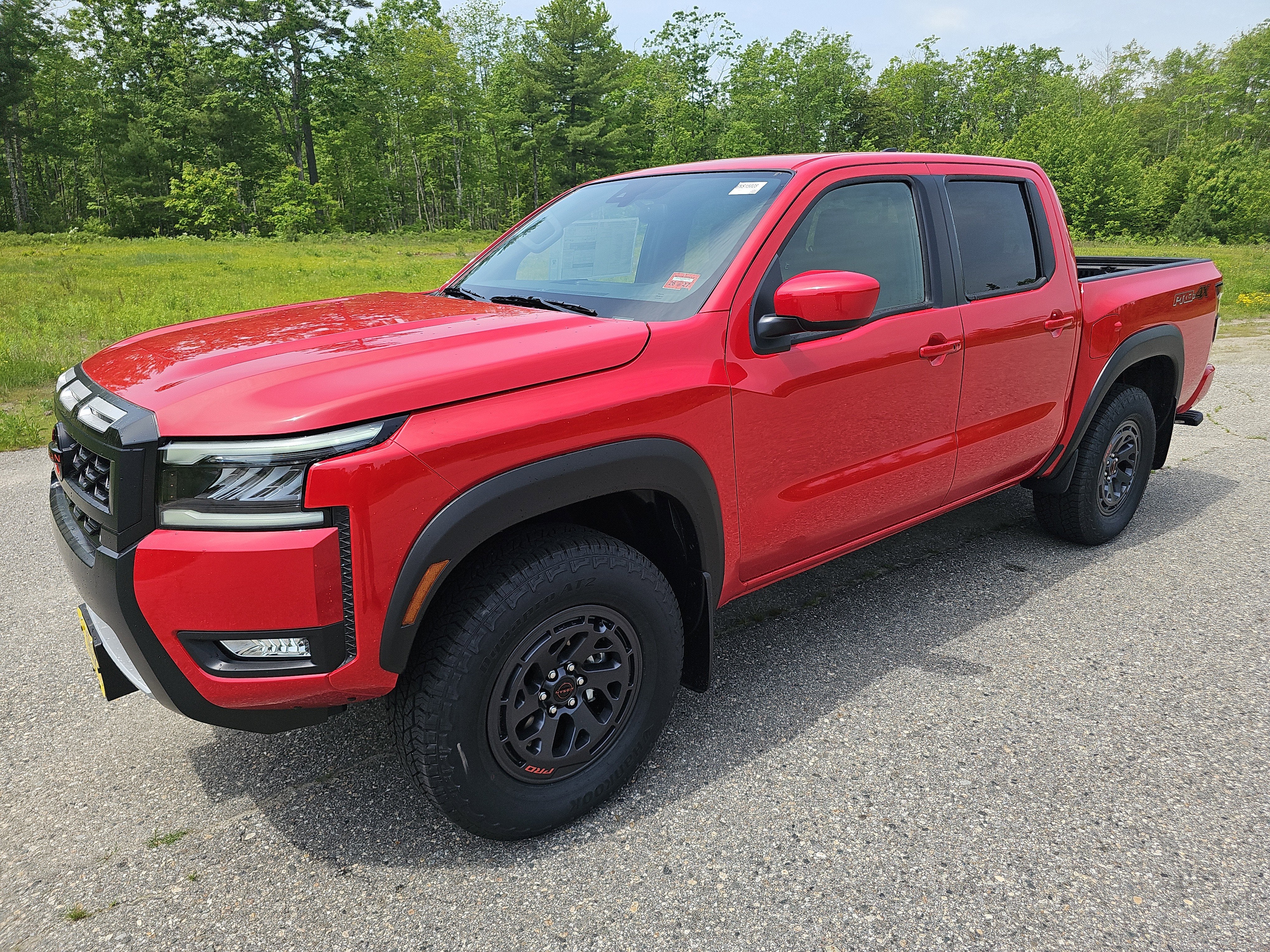2026 Nissan Frontier PRO-4X in Red Alert — front three-quarter view