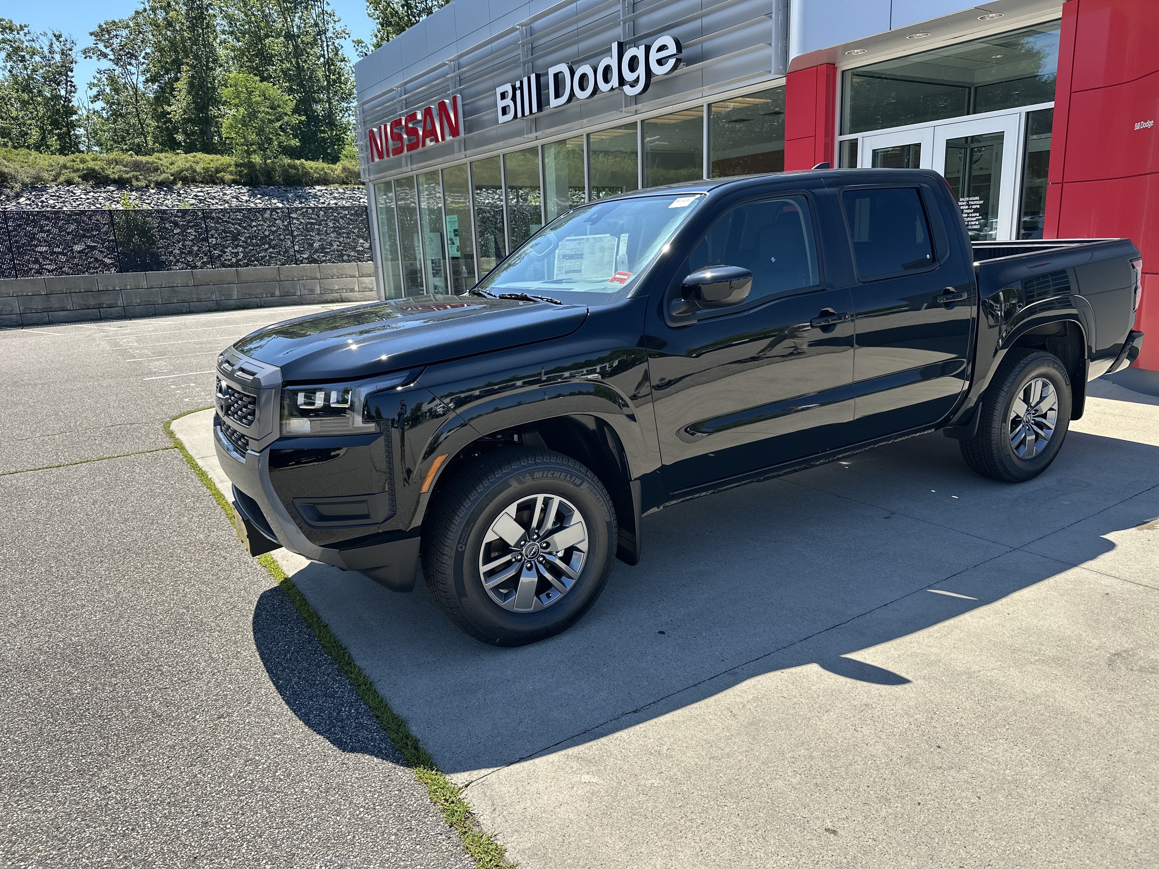 2026 Nissan Frontier SV in Super Black — front three-quarter view