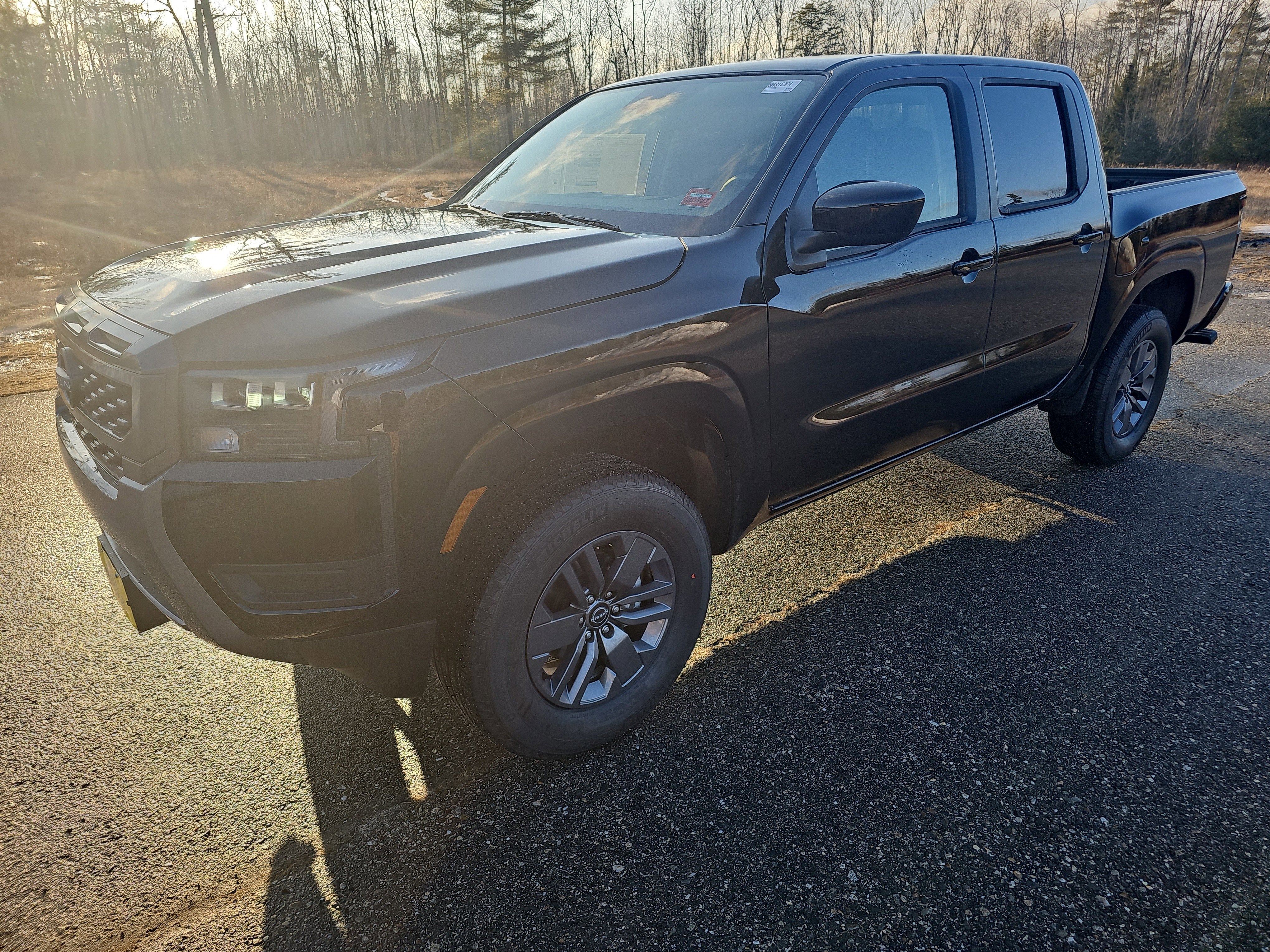2026 Nissan Frontier SV in Super Black — front three-quarter view