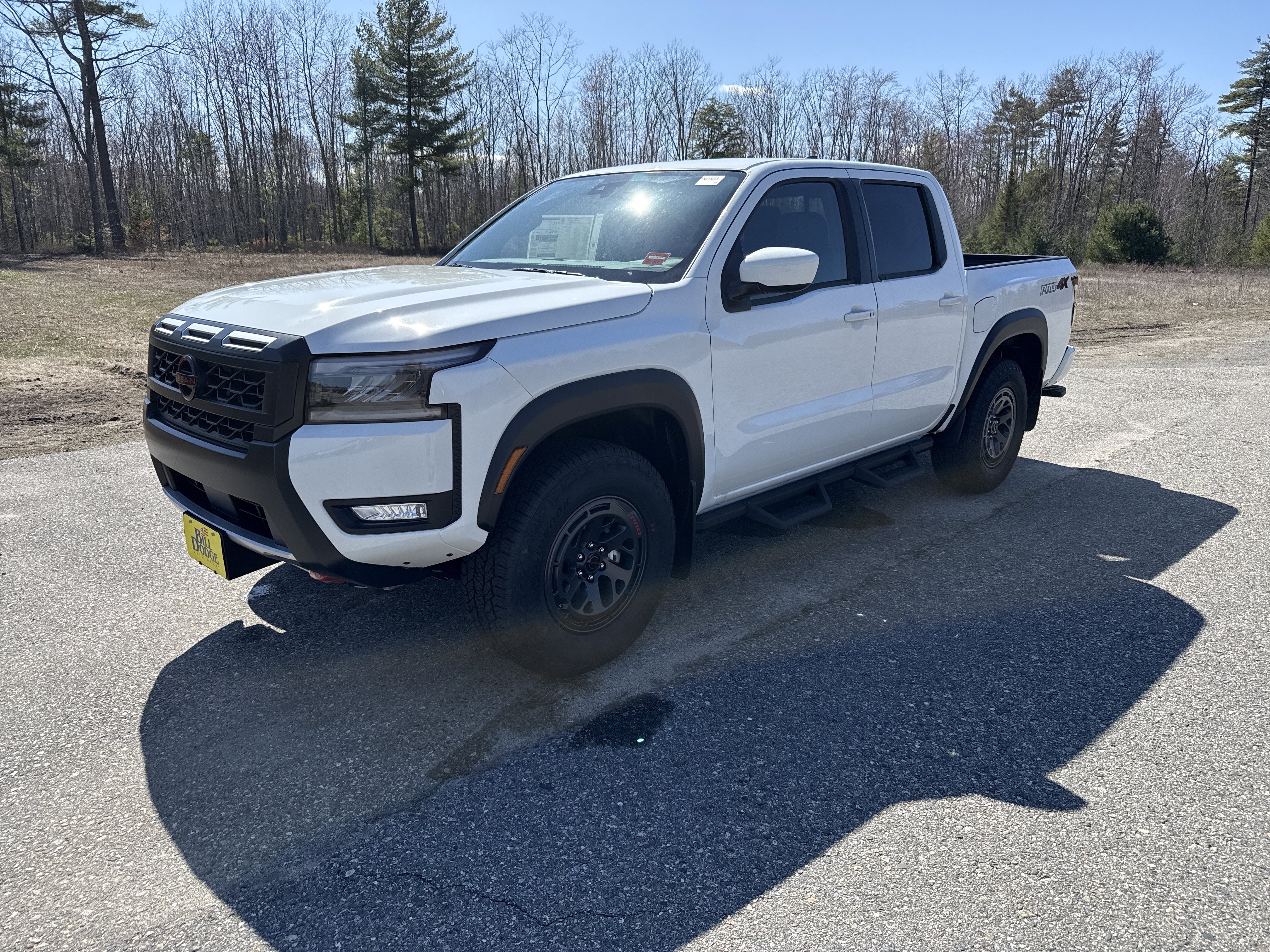 2026 Nissan Frontier PRO-4X in Glacier White — front three-quarter view