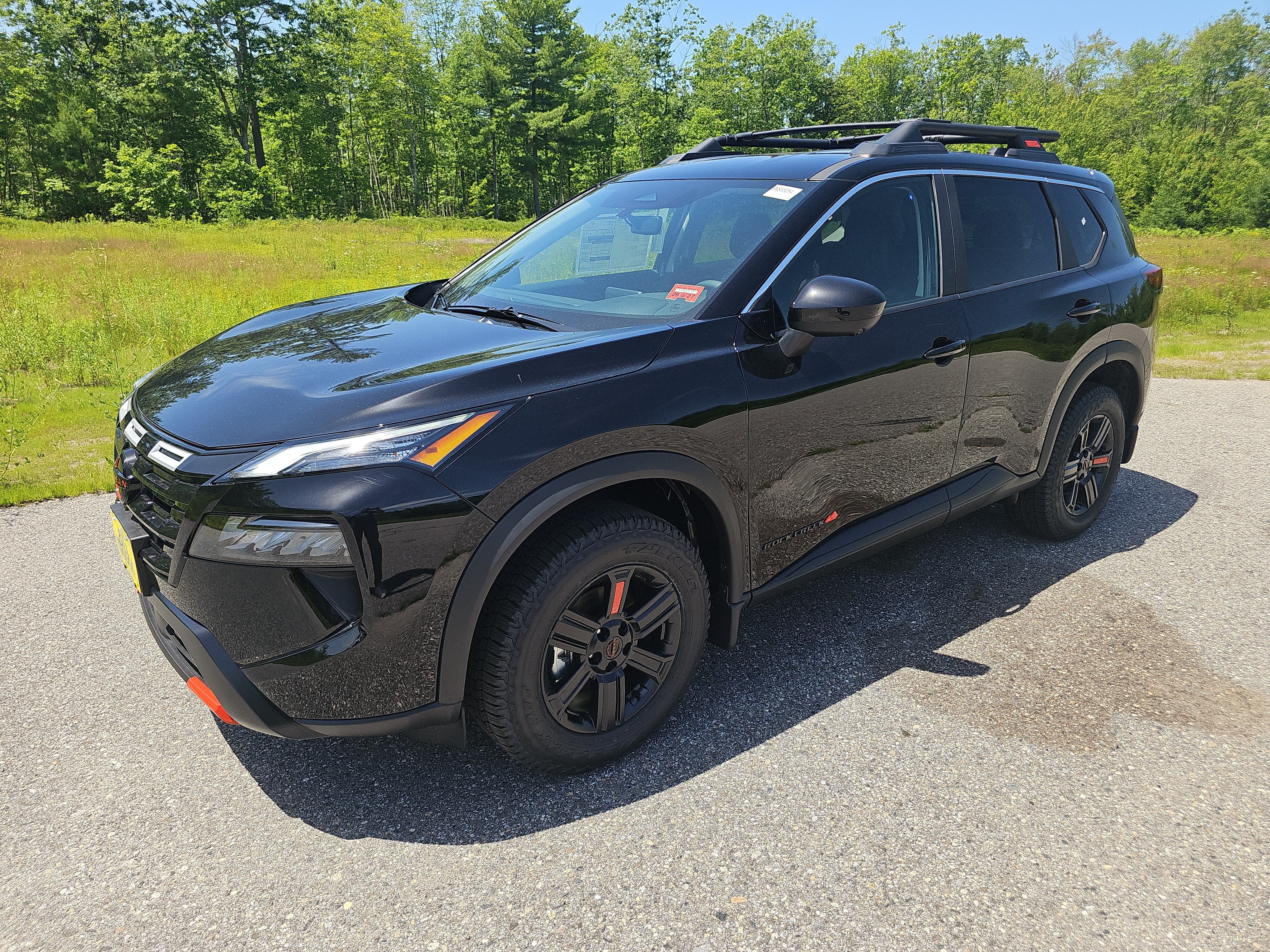 2026 Nissan Rogue Rock Creek in Super Black — front three-quarter view