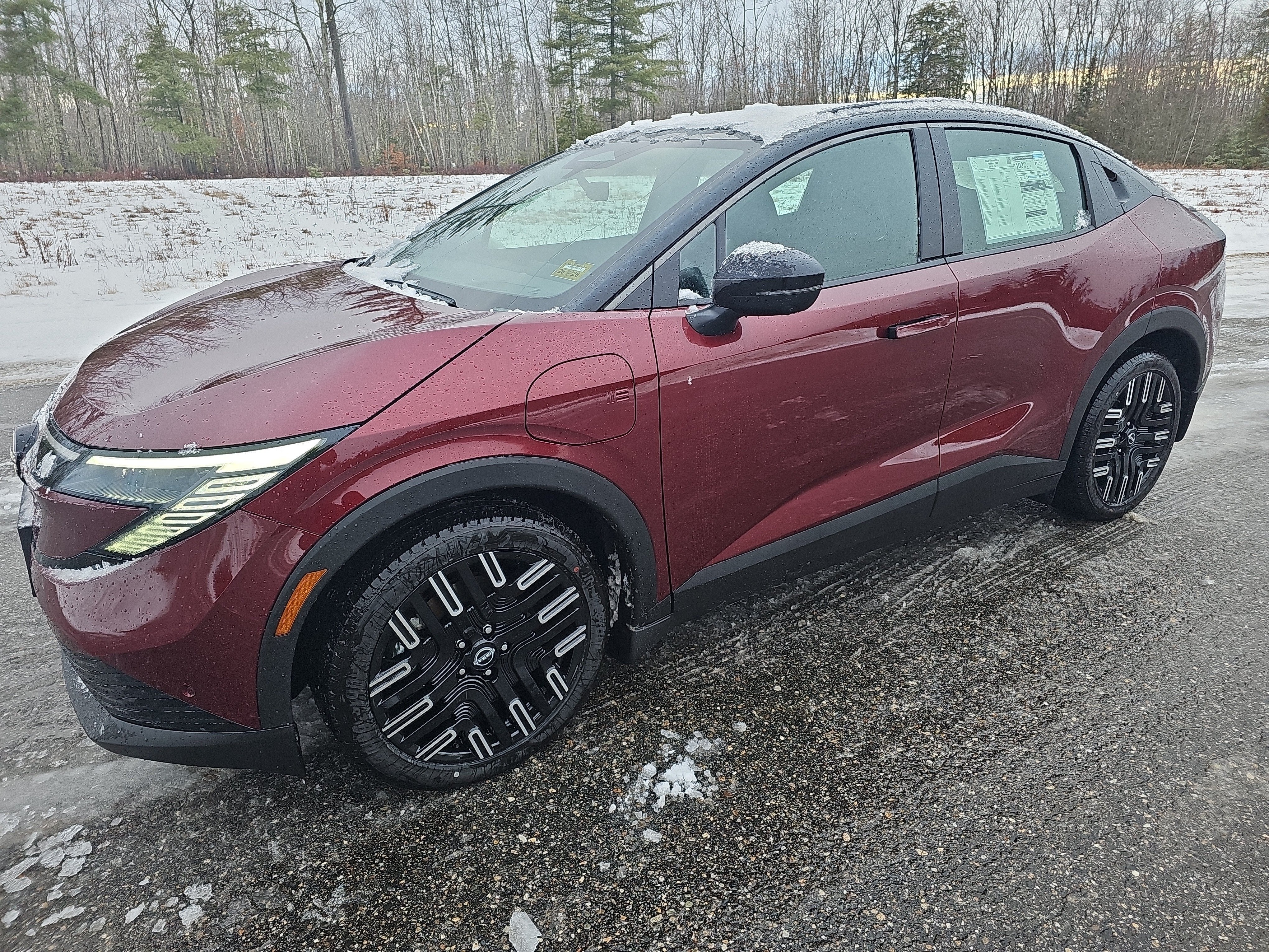 2026 Nissan LEAF PLATINUM+ in Coulis Red Metallic/Black — front three-quarter view
