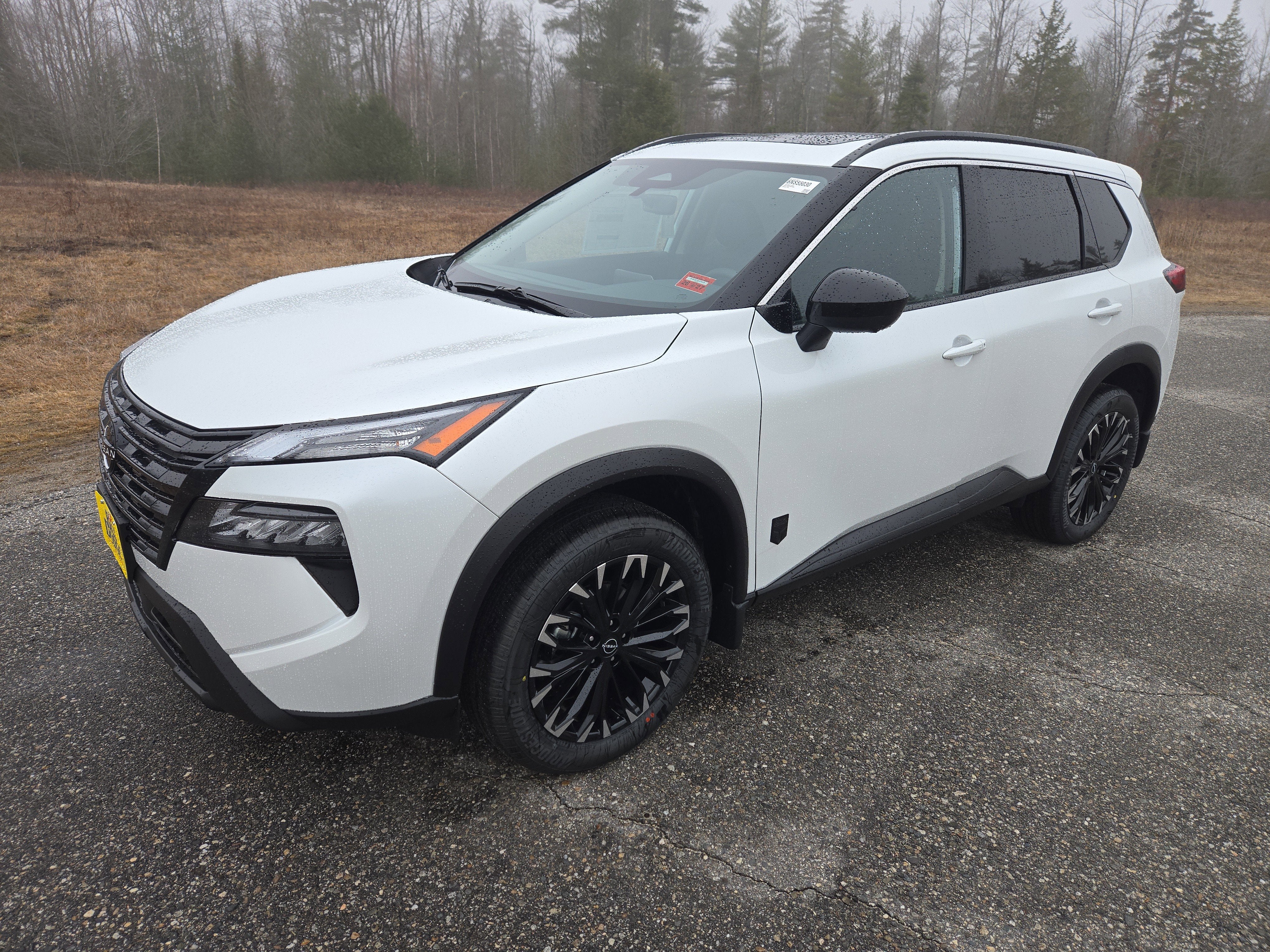 2026 Nissan Rogue Dark Armor in Everest White Pearl Tricoat — front three-quarter view
