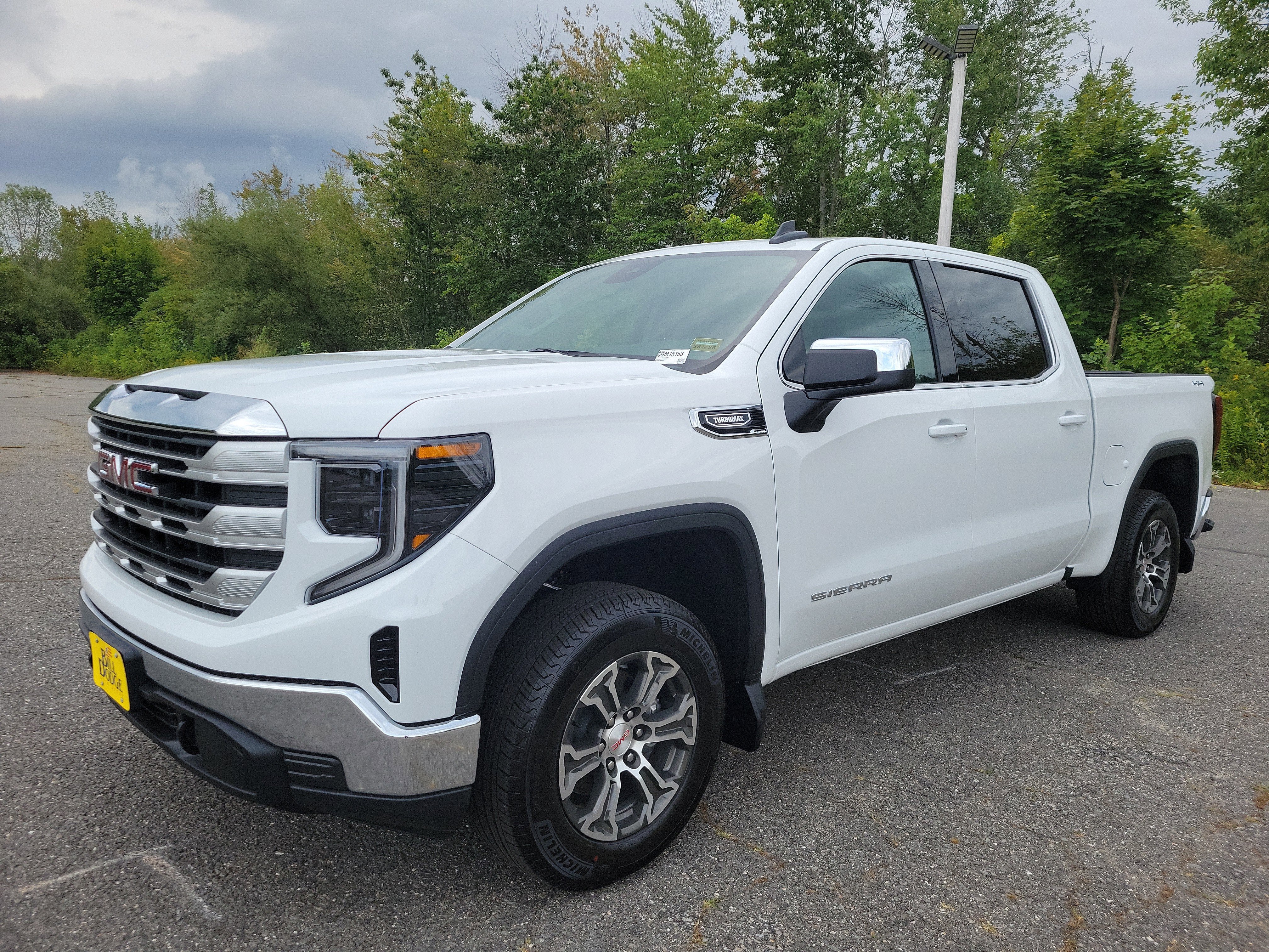 2026 GMC Sierra 1500 SLE in Summit White — front three-quarter view