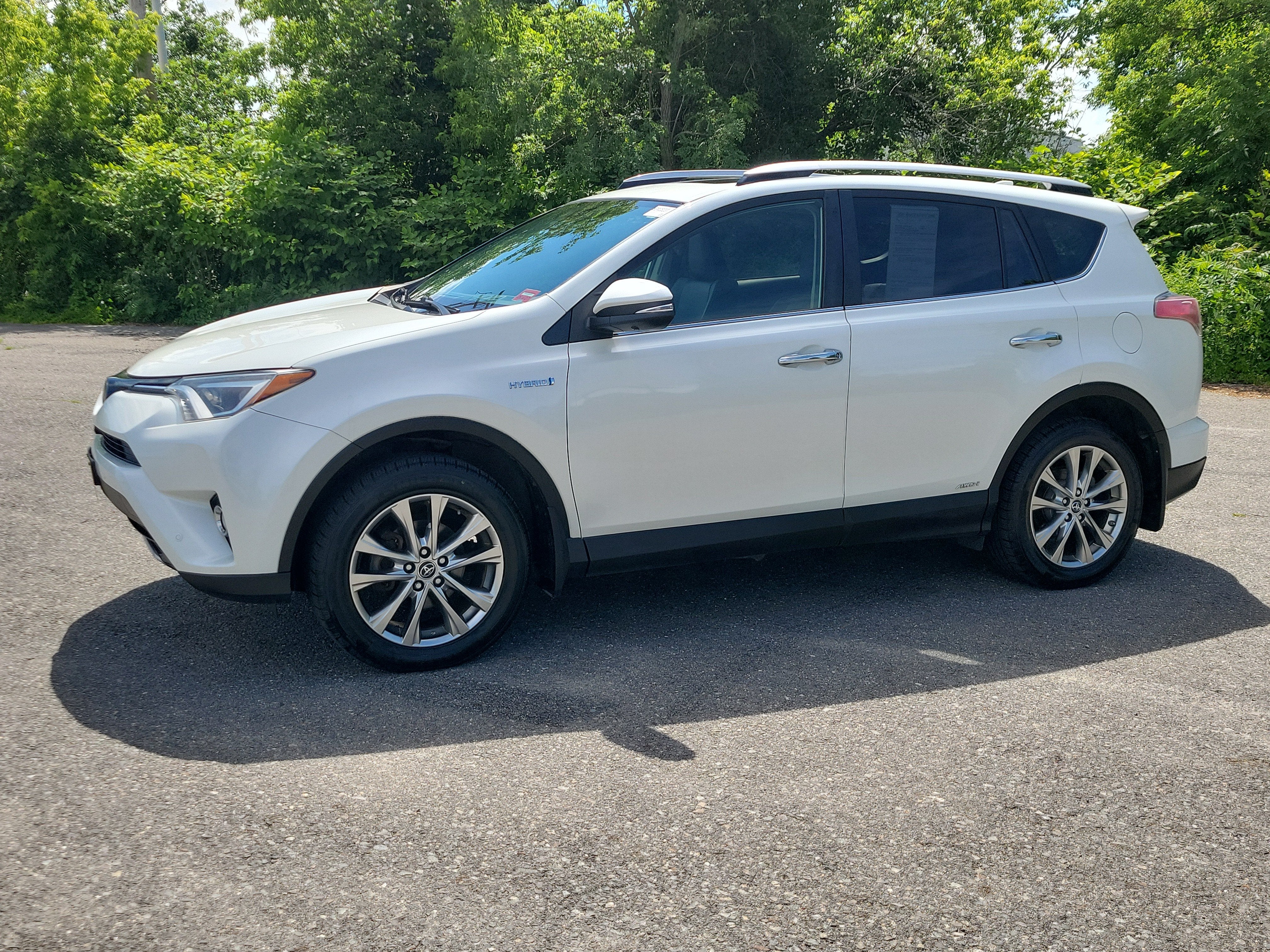2016 Toyota RAV4 Hybrid Limited in White — front three-quarter view